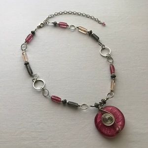 Glass beaded necklace with pink and silver pendant